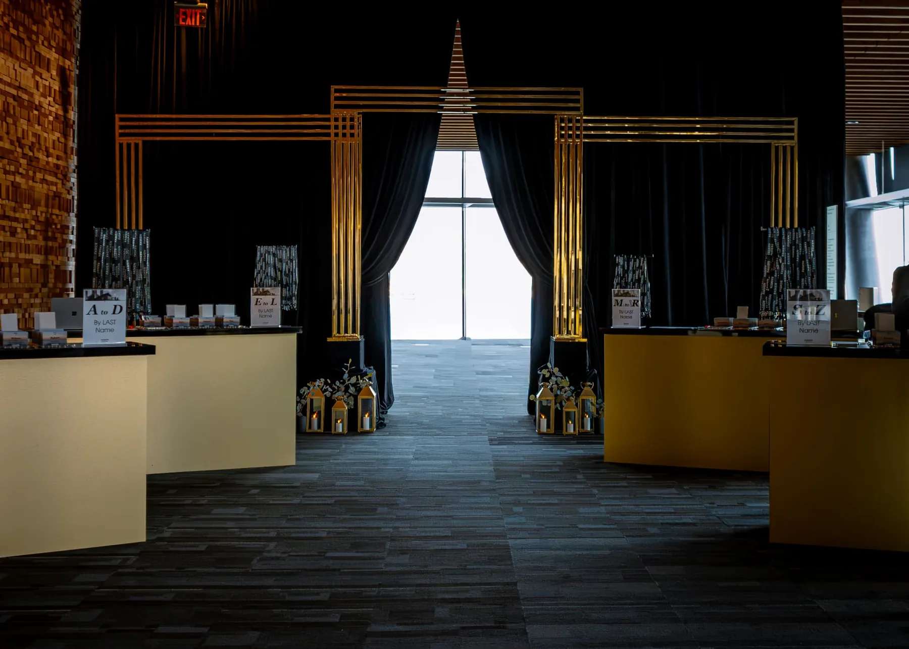 Gold frame entrance with black drapery and lanterns